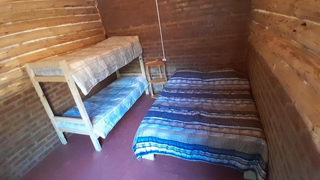 two bunk beds in a wooden room with at Patriada Ranch in El Hoyo