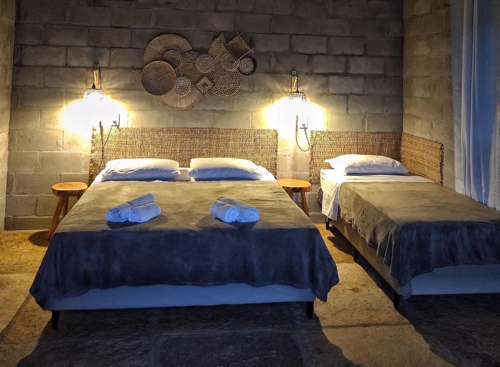 ein Schlafzimmer mit 2 Betten und Handtüchern darauf in der Unterkunft Alto das Carnaúbas Chalé in Luis Correia