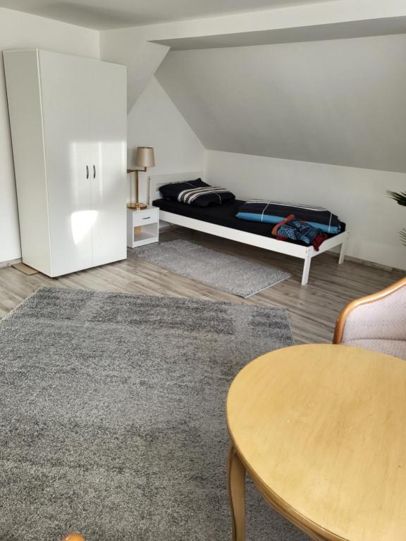 a living room with a bed and a table at Fahrer- und Logistikservice in Hecklingen