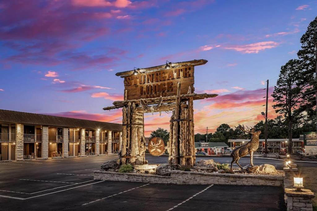 a statue of a giraffe in a parking lot at Stonegate Lodge King Bed, WiFi, 50in TV, Fire Pit, Salt Water Pool Room # 310 in Eureka Springs