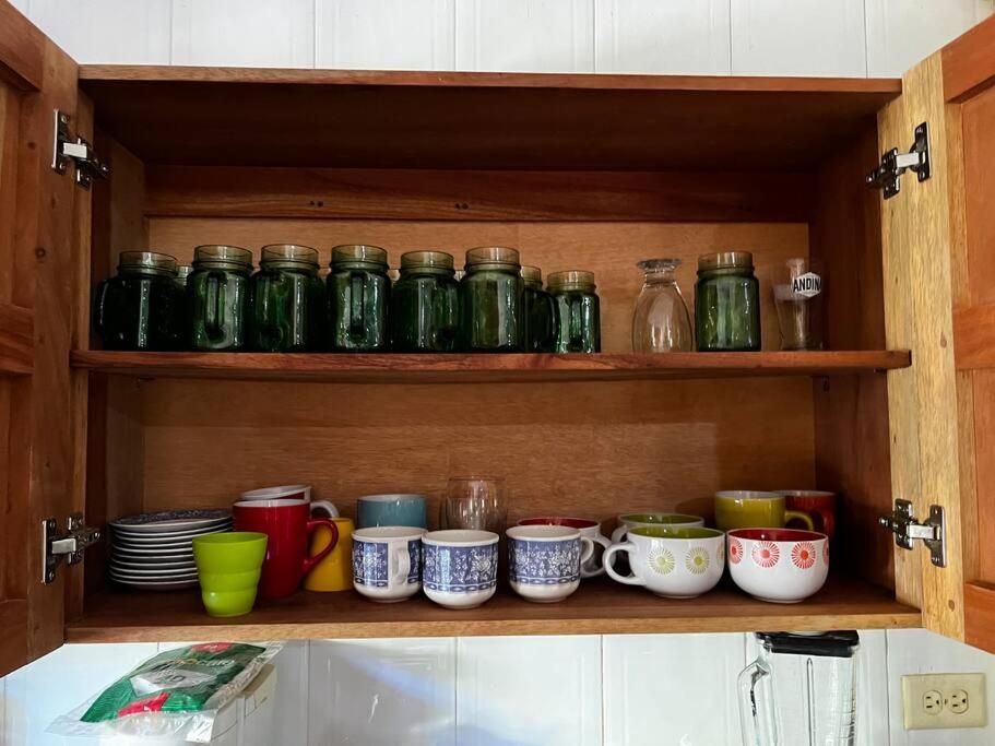 a cabinet filled with lots of cups and plates at Casa finca Santiago Tolú 