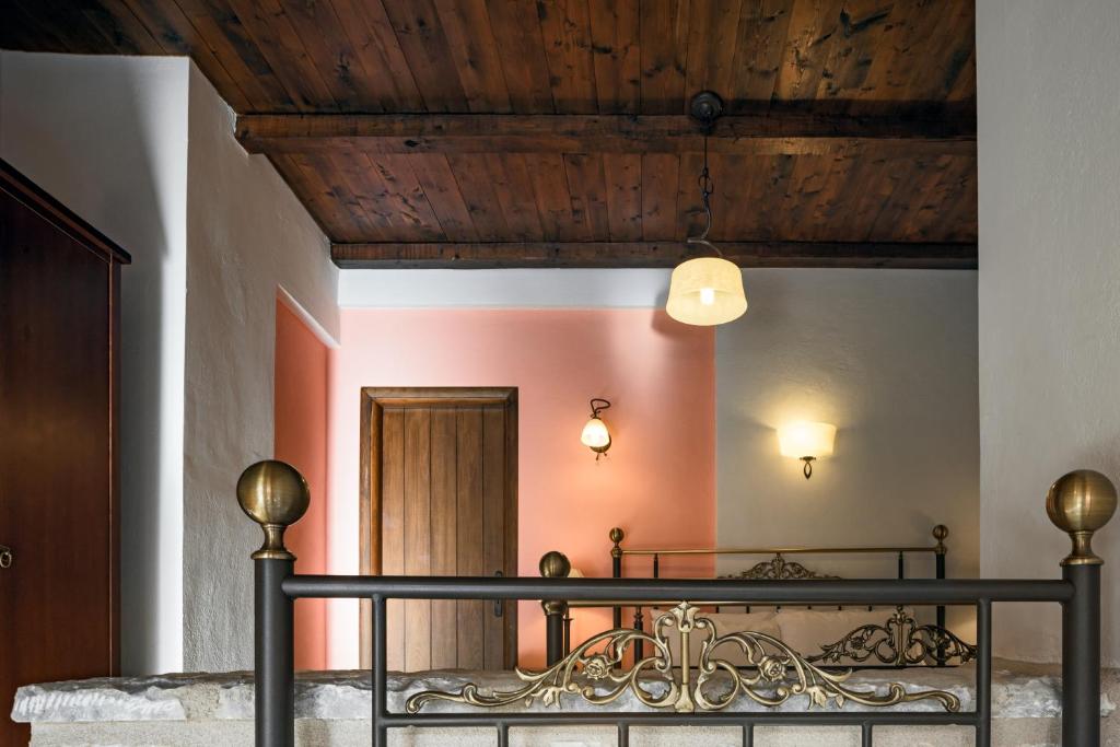 a room with a railing and a wooden ceiling at Porto Kale Guesthouse in Porto Kagio