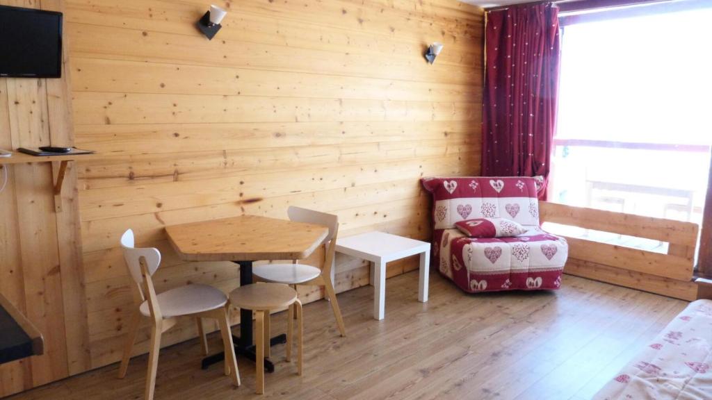 um quarto com uma mesa e cadeiras e um sofá em Résidence Tournavelles - Studio pour 3 Personnes 81 em Arc 1800