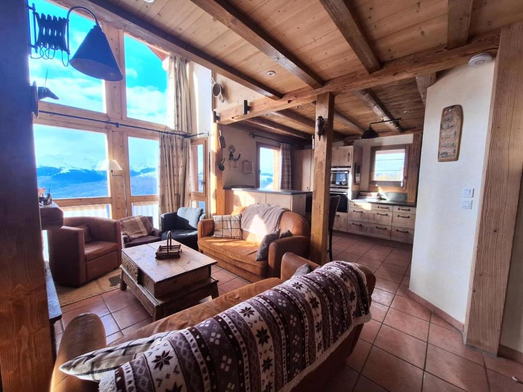 a living room with a couch and a table at Chalet De Bellecote - Chalets pour 8 Personnes 96 in Peisey-Nancroix