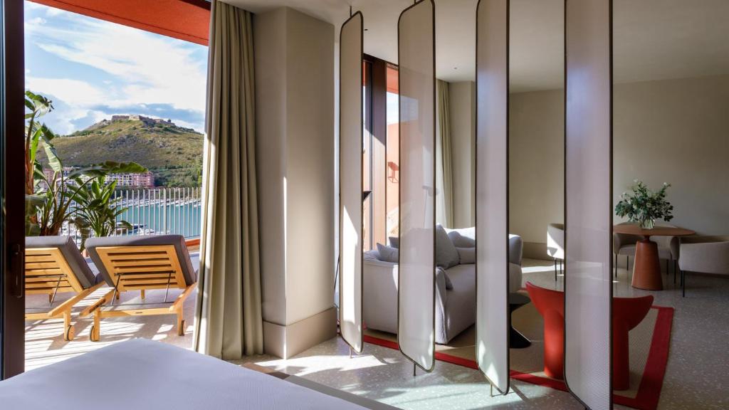 a hotel room with a view of a balcony at La Roqqa in Porto Ercole