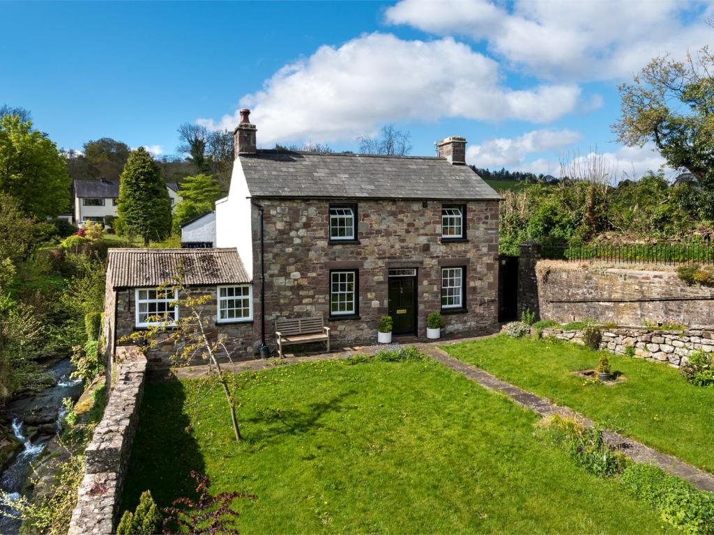 an old stone house with a grass yard at 4 Bed in Llangynidr BN305 in Llangynidr