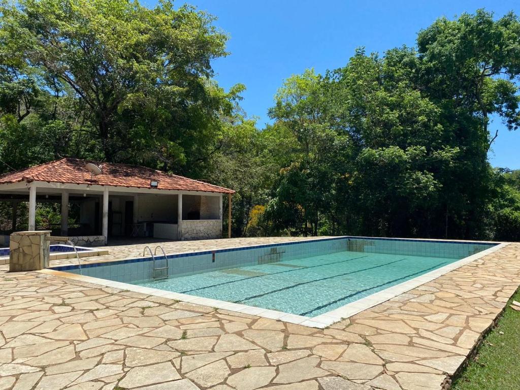 a swimming pool in front of a house at Vilarejo Ecológico terra de canaã in Brasília