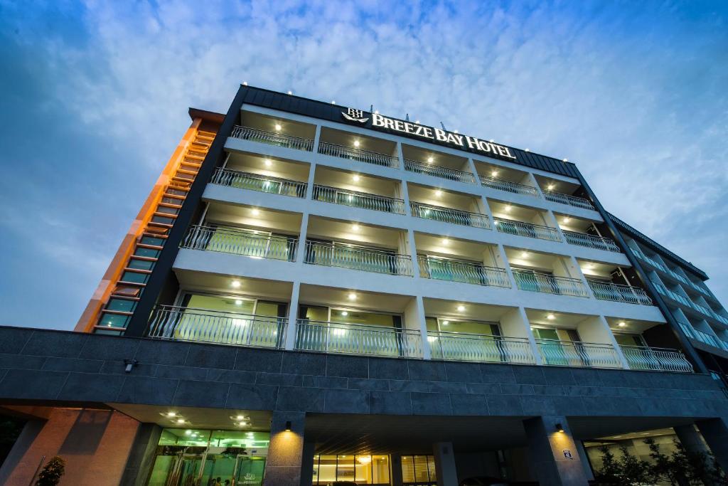 a building with a sign on the side of it at Breeze Bay Hotel in Seogwipo