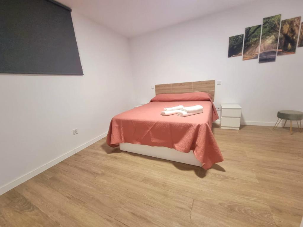 a bedroom with a bed with a red comforter at Vivienda El Viajero in Valverde