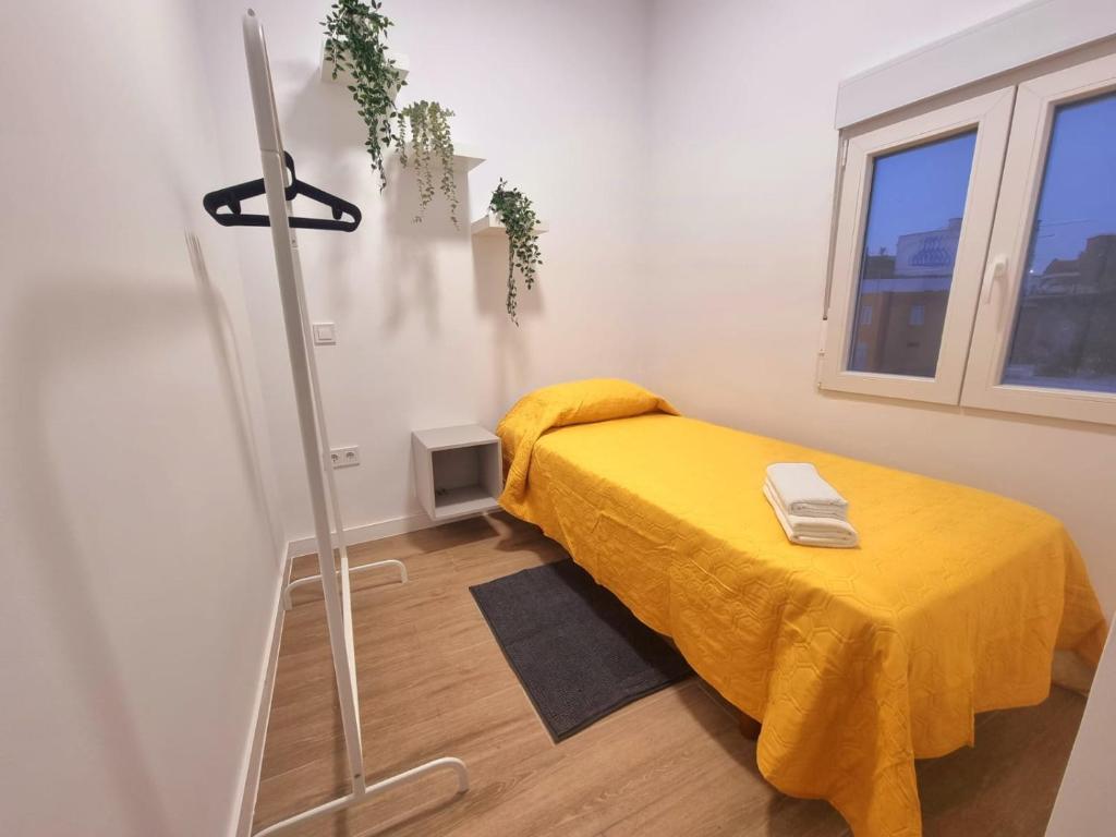 a room with a bed with a yellow blanket at Vivienda El Viajero in Valverde