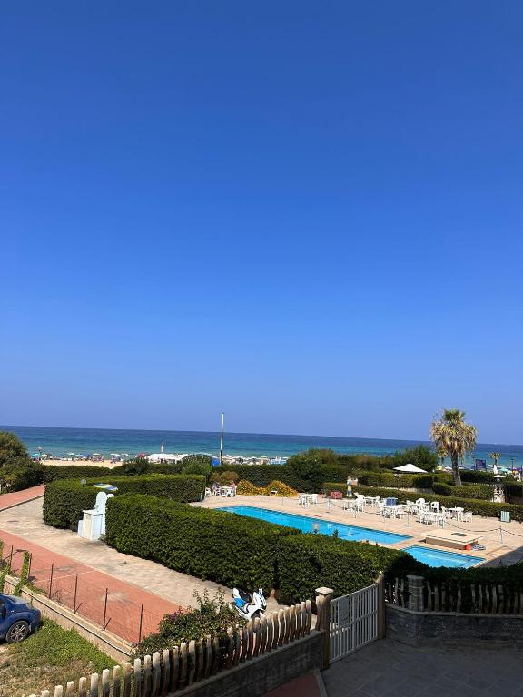 a view of a swimming pool with the ocean in the background at La casa al Mare in Erice