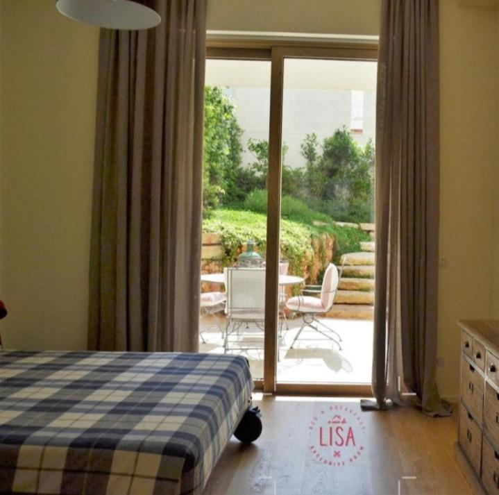 a bedroom with a bed and a view of a patio at A CASA DA LISA (exclusive room) in Turi