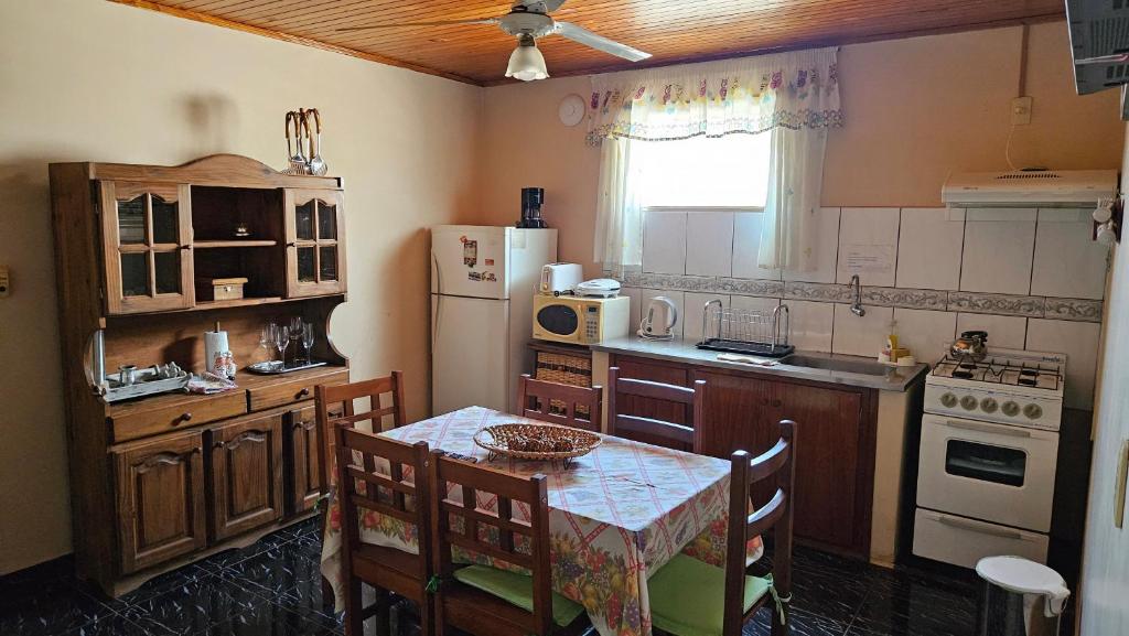 una pequeña cocina con mesa y nevera en Casa Giovanini en Puerto Iguazú