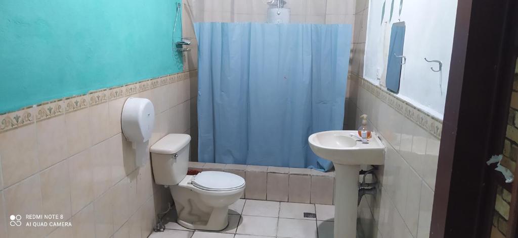 a bathroom with a toilet and a sink at Karim Hostel in Guatemala