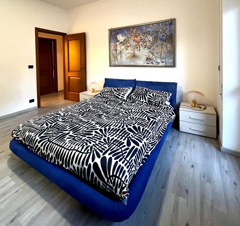 a bedroom with a blue bed with a zebra blanket at Pearl of Sea in Lido di Ostia