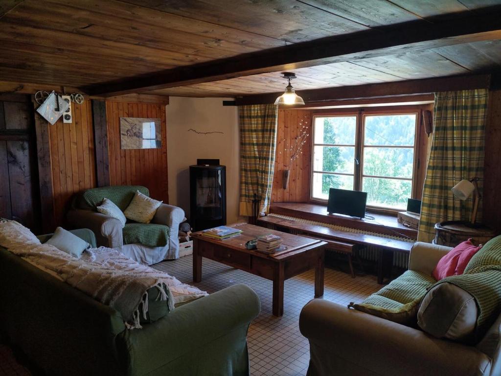 a living room with two couches and a table at Chalet La Gayolle - Chalets pour 12 Personnes 96 in Saint-Gervais-les-Bains