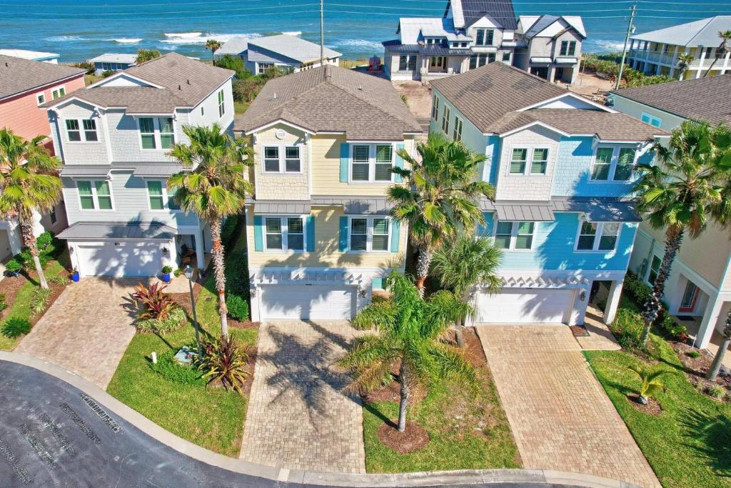 an aerial view of a row of houses with palm trees at Sunset Inlet Luxury Oasis | Flagler Beach in Flagler Beach