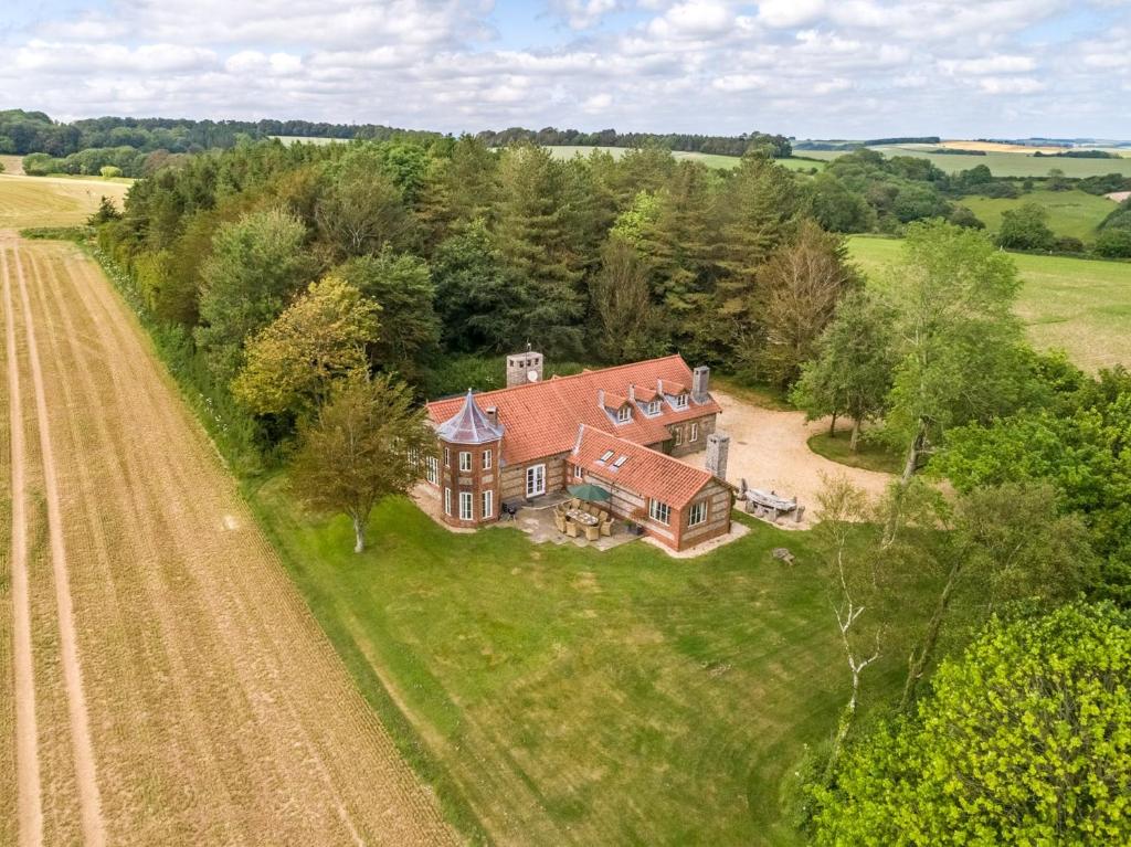 an aerial view of a large house in a field at 4 Bed in Dorchester 80513 in Charminster