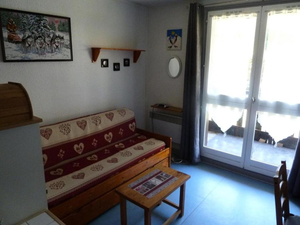 un salon avec un canapé et une fenêtre dans l'établissement Résidence Les Cretes - Studio cabine 4 personnes 2 exposé Sud MAE-8044, à Valloire