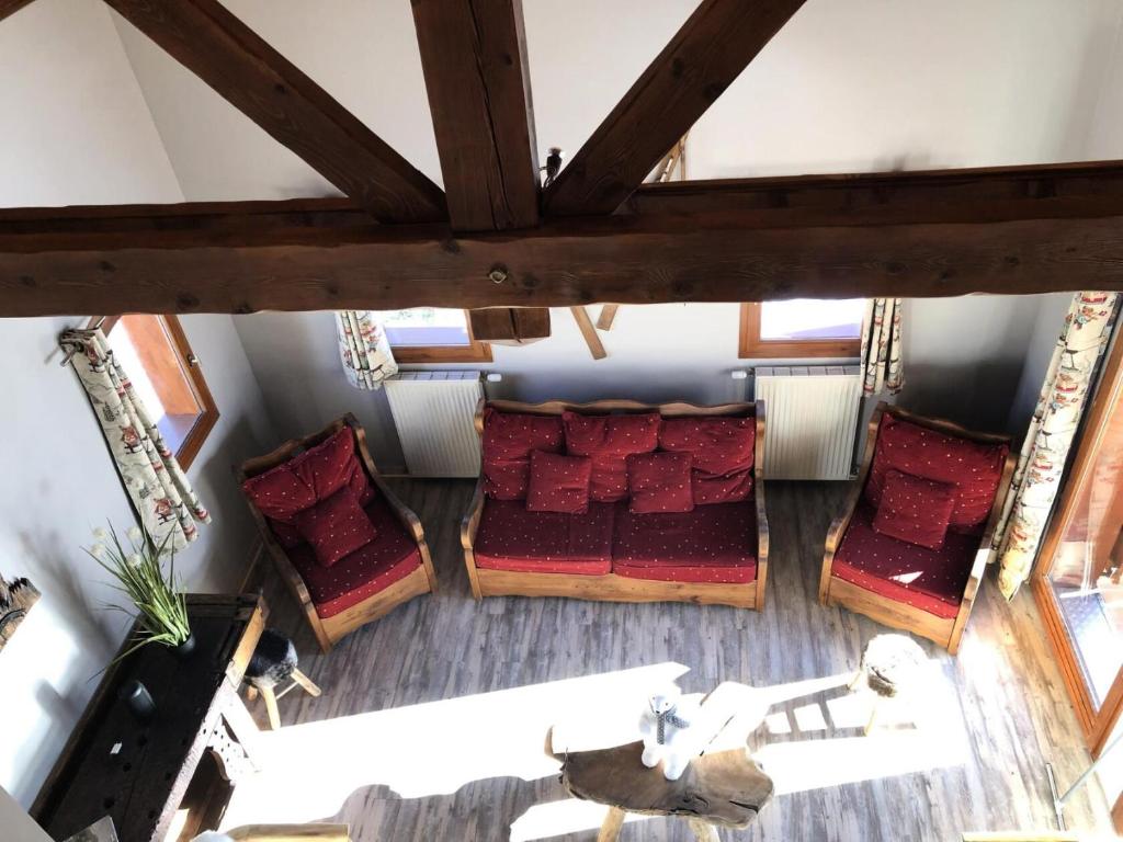 an overhead view of a room with red pillows at Chalet Colenfrey - Chalets pour 10 Personnes 14 in Valloire