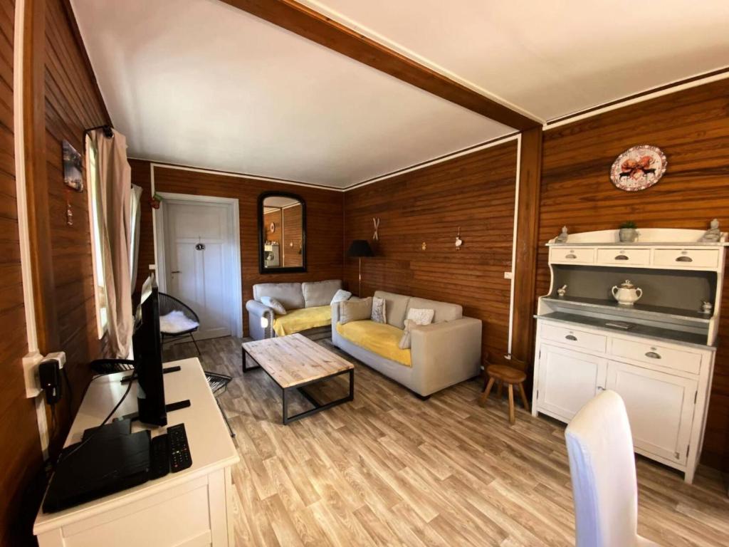 un salon avec un canapé et une table dans l'établissement Chalet Ufia - Bel appartement dans un ancien chalet rénové proche du centre de Barèges MAE-8674, à Barèges