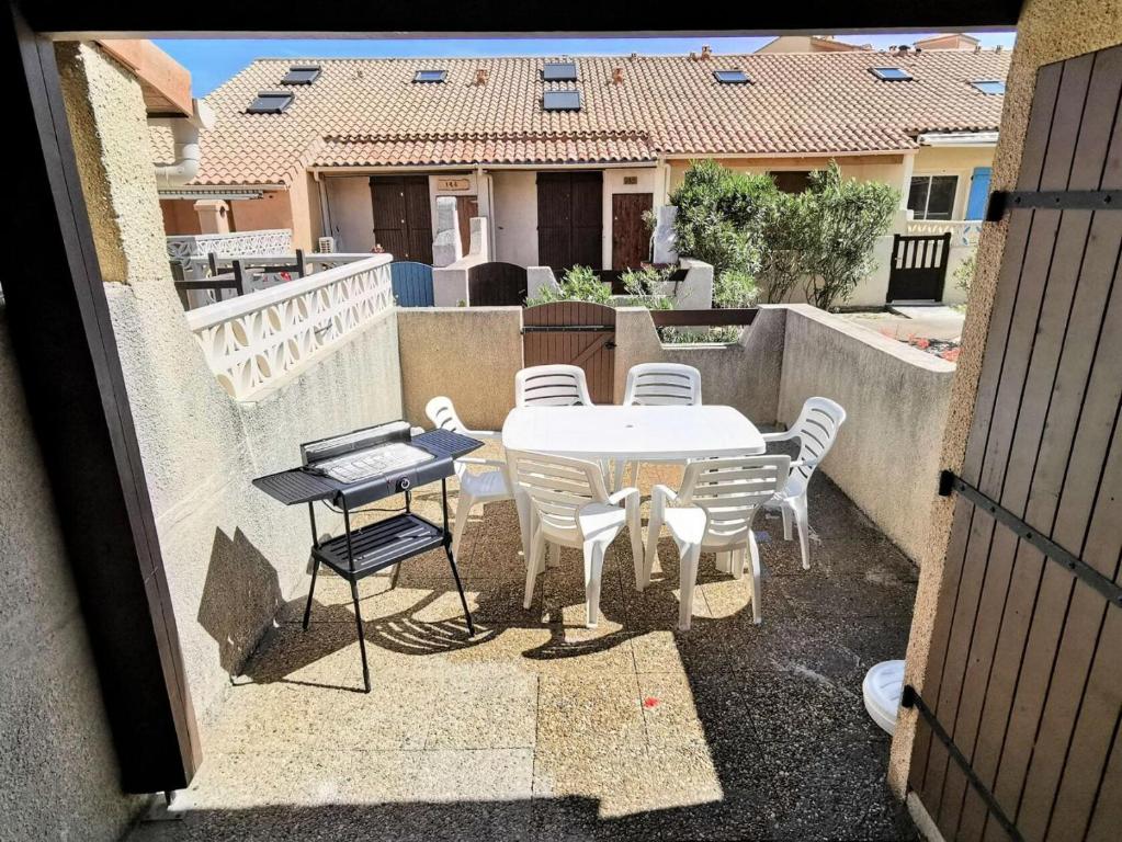 une table et des chaises sur le balcon d'une maison dans l'établissement Résidence Grande Bleue - Villa trois pièces 6 couchages PORT LEUCATE. Réf: 3GB_152 MAE-5234, à Port-Leucate