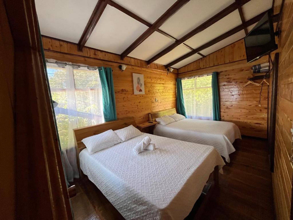 Postel nebo postele na pokoji v ubytování Cabañas el Bosque
