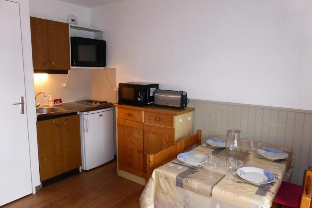 - une petite cuisine avec une table et des plaques de cuisson dans l'établissement Résidence Le Royal - Royal 12 MAE-9034, à Combloux