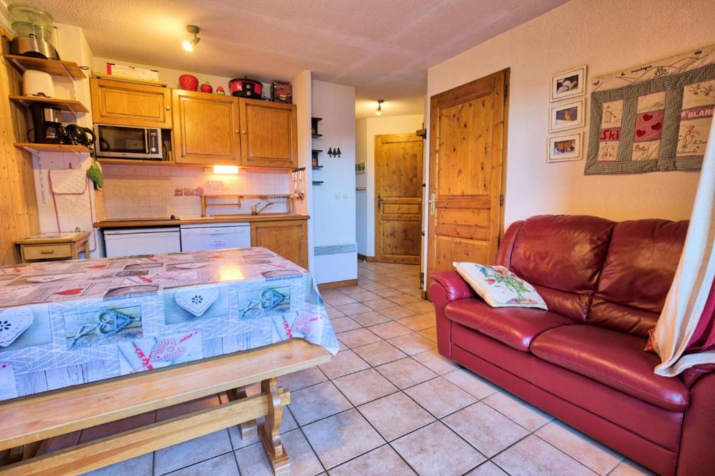 a living room with a couch and a kitchen at Résidence Les Oursons - 2 Pièces pour 4 Personnes 354 in Notre-Dame-de-Bellecombe