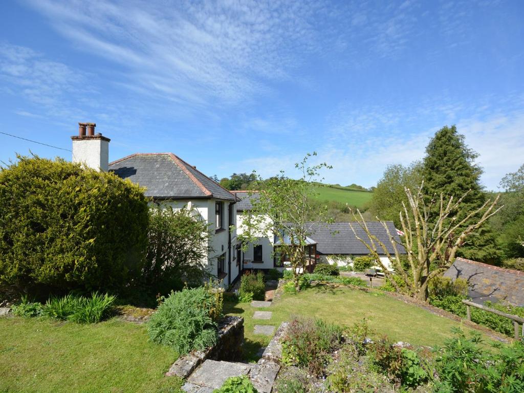 a white house with a garden in front of it at 3 Bed in Dulverton RDOOR in Exton