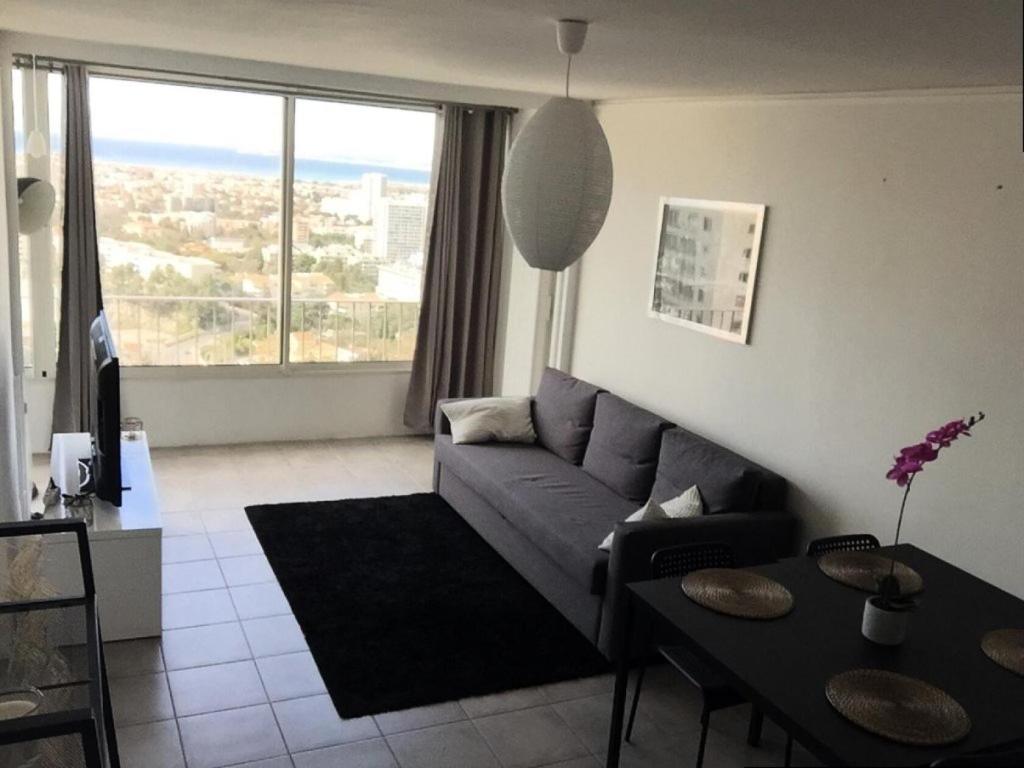 un salon avec un canapé et une table dans l'établissement Résidence La Rouviere - Grand appartement proche départ des Calanques MAE-7664, à Marseille