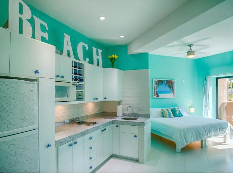 a blue bedroom with a bed and a sink at Great spot @ Marina, all Cabo's lifestyle on hand in Cabo San Lucas