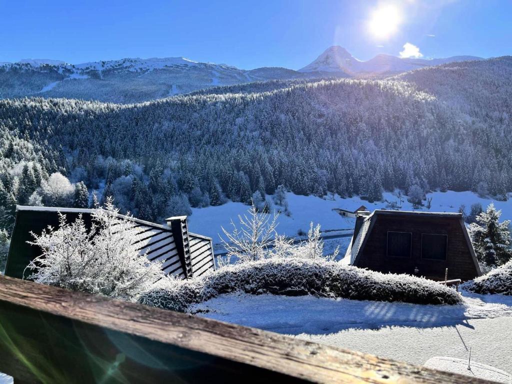 a view of a snow covered mountain and a lake at Résidence Le Peuil - Chalets pour 8 Personnes 454 in Corrençon-en-Vercors