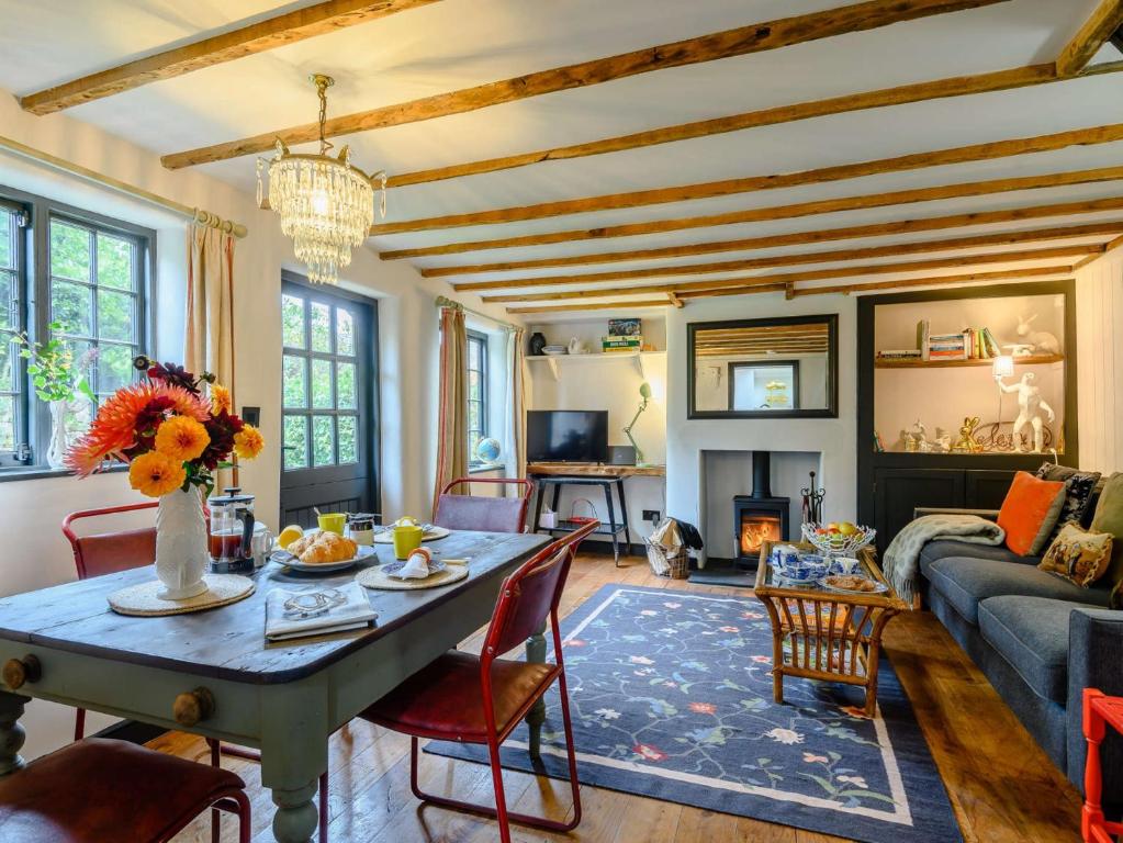 a living room with a table and a couch at 1 Bed in Bridport 89687 in Bridport