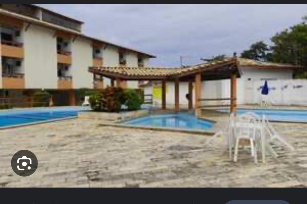 a swimming pool in front of a building at Maresia 7B in Salvador