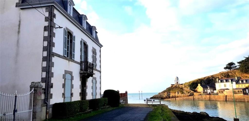 a building next to a body of water at Résidence -pleneuf Val Andre - Maisons & Villas 694 in Pléneuf-Val-André