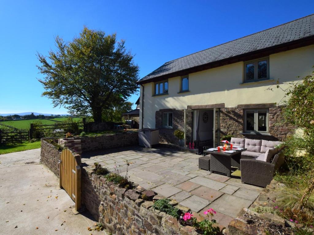 a stone patio in front of a house at 3 bed property in Winkleigh 66041 in Winkleigh