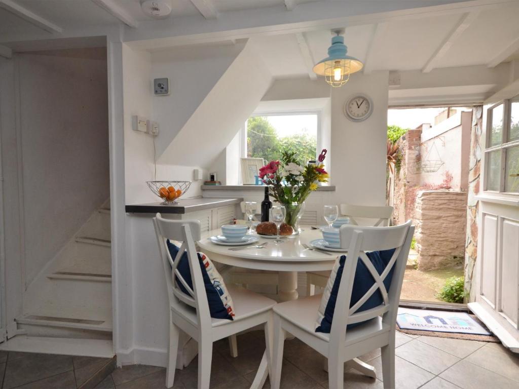a kitchen and dining room with a table and chairs at 2 bed in Brixham BX021 in Brixham