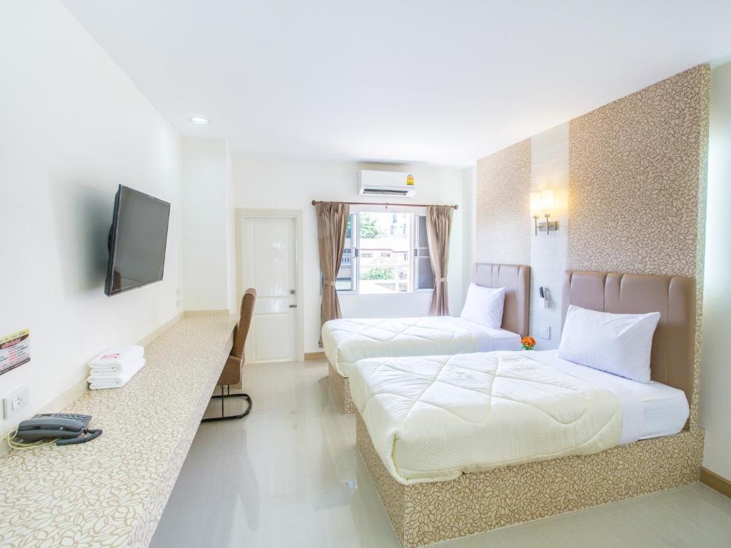 Postel nebo postele na pokoji v ubytování P.A. Thani Hotel