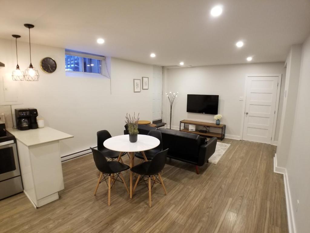 蒙特婁的住宿－Modern and spacious 2 bedroom in Montreal，厨房以及带桌椅的起居室。