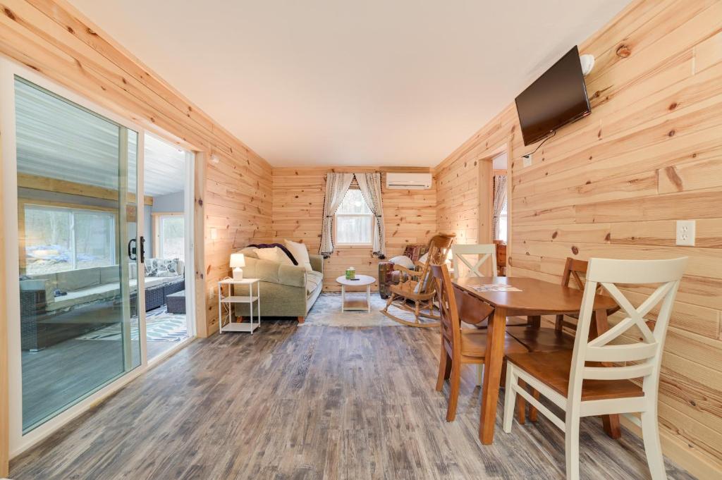 uma sala de estar com uma parede de madeira em Scenic Evans Hideaway Steps to Lake Huron! em Oscoda
