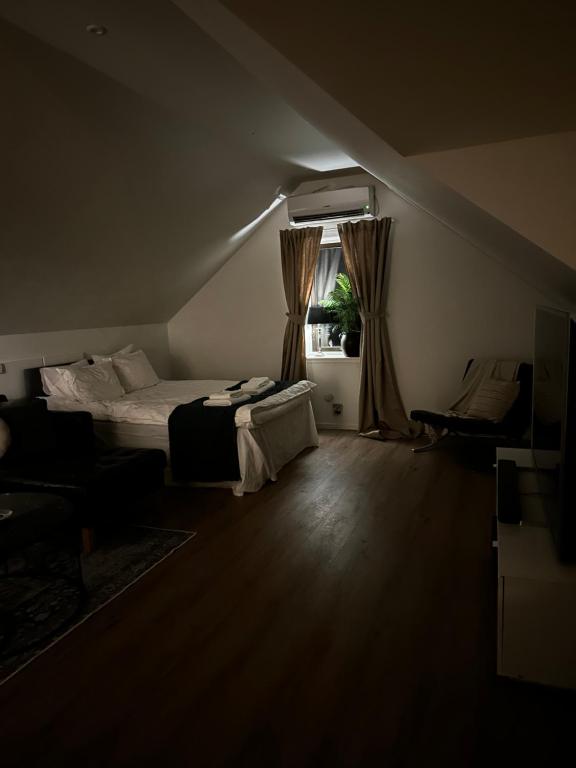 a dark room with a bed and a window at Landvetter Airport B&B in Härryda