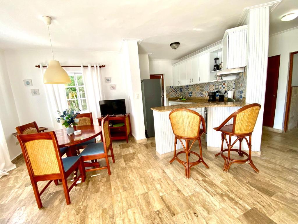 a kitchen and dining room with a table and chairs at Beach and pool life in Punta Cana