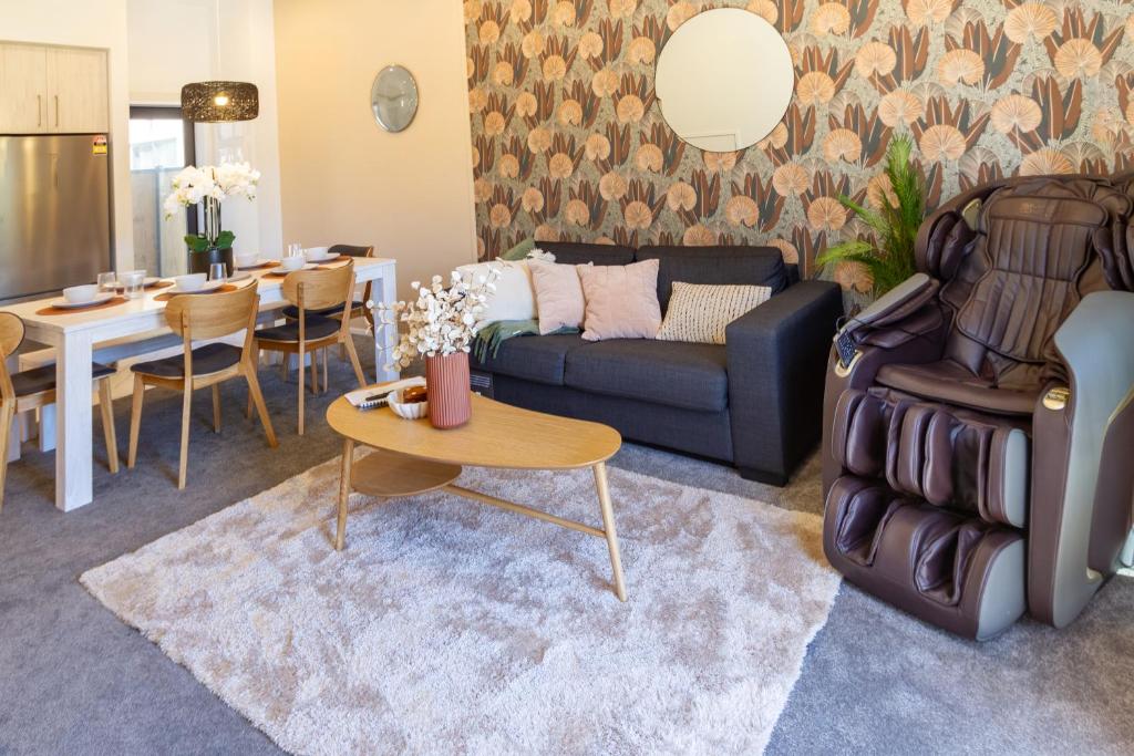 a living room with a couch and a table at 3 Bedroom Hagley Park Paradise in Christchurch
