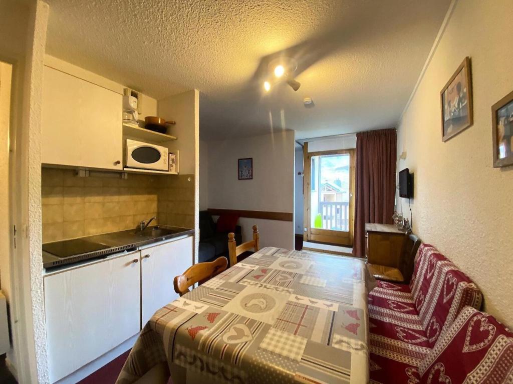Cette petite chambre comprend un lit et une cuisine. dans l'établissement Résidence Cimes De Caron - Exposé sud, quartier calme pour 4 personnes MAE-2094, à Val Thorens