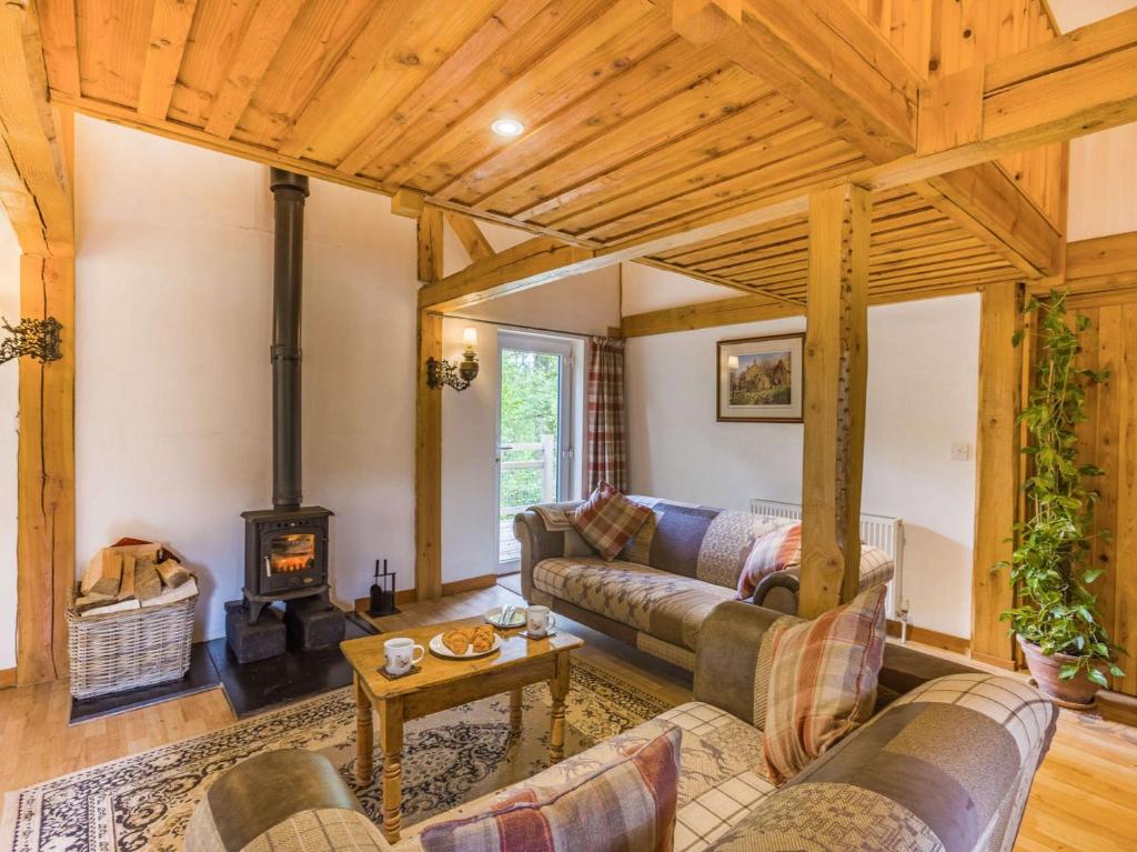 a living room with a couch and a wood stove at 3 Bed in Chulmleigh 87779 in Eggesford
