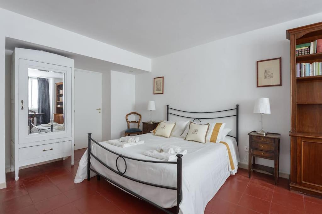 a bedroom with a large bed and a mirror at Discover the Pantheon from The Berardi Studio Flat in Rome