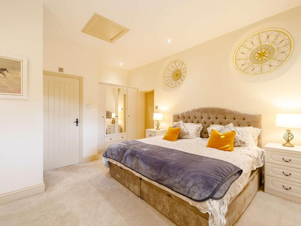 a bedroom with a large bed with yellow pillows at 2 Bed in Rowlands Gill 89758 in Stanley