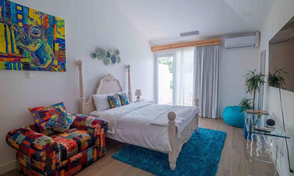 sypialnia z łóżkiem i kanapą w obiekcie Palacio Pura Vibra w mieście Ciudad Cariari
