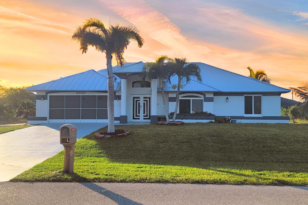 a house with a palm tree and a parking meter at Sunsets by the Water in Cape Coral